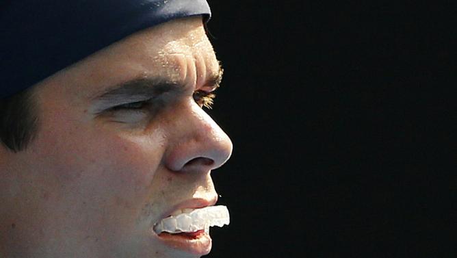 Canada's Raonic bites his mouthguard during his fourth round match against Switzerland's Wawrinka at the Australian Open tennis tournament at Melbourne Park